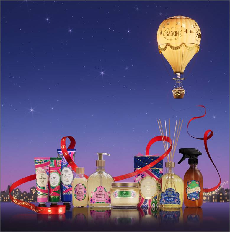 The SABON holiday collection under a starry sky, with a golden hot air balloon